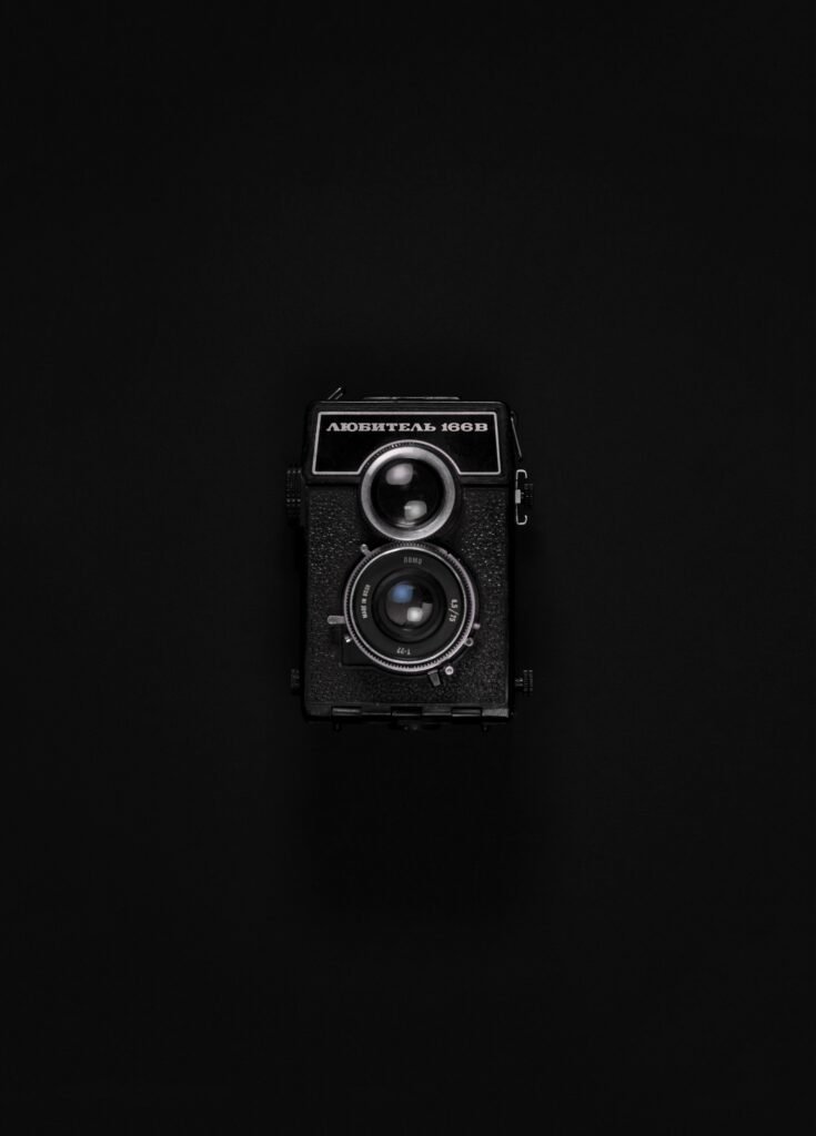A classic Soviet film camera displayed against a sleek black backdrop.