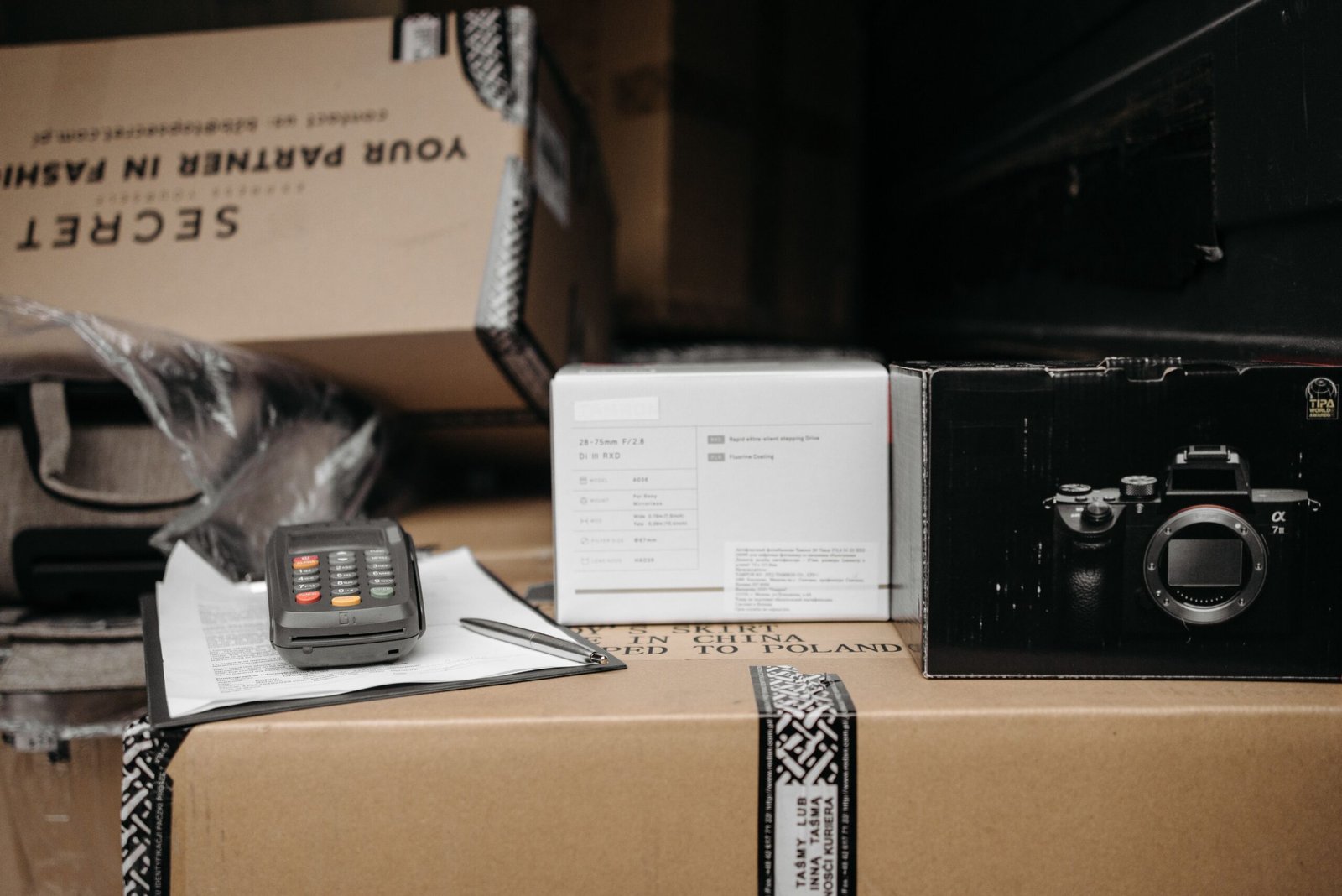 Assorted packages with camera equipment ready for shipment in an indoor setting.